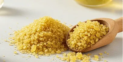 Yellow alpha lipoic acid crystals on a wooden scoop